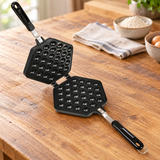 Open Bubble Waffle Maker beside batter and eggs
