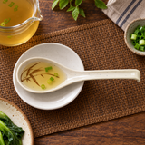 023-J beige Autumn Grass melamine soup spoon in an overhead serving view