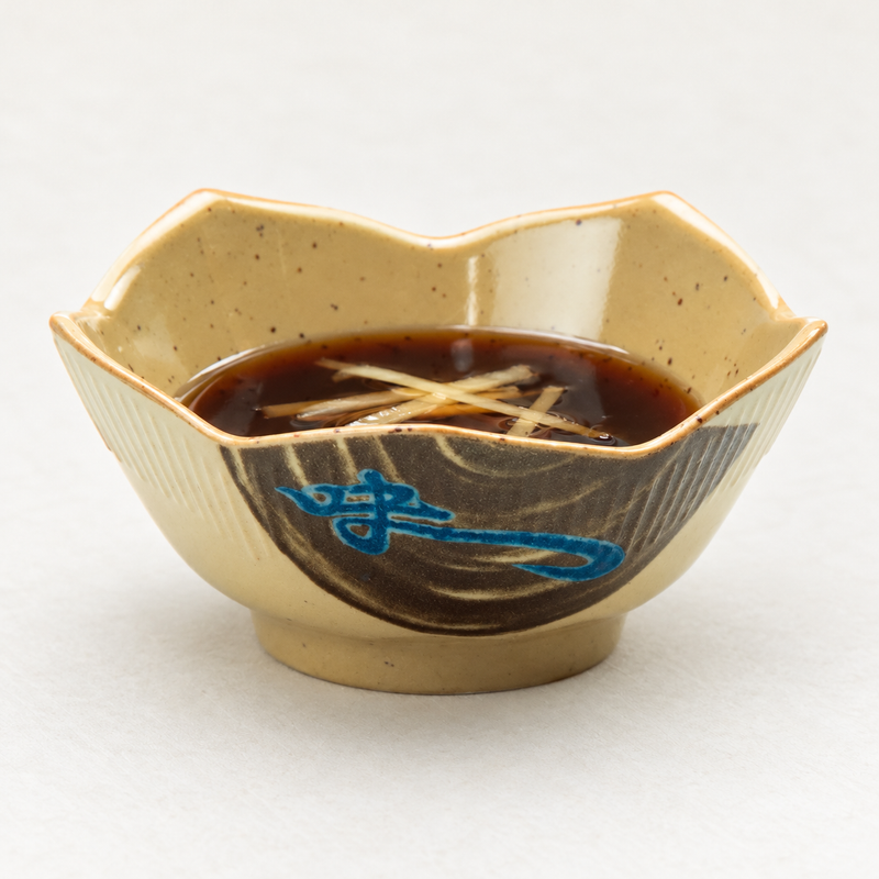 The 1036J Wei lotus-shaped melamine bowl holding a dark sauce with fine pale garnish strips.