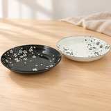 Black and white floral plate pair in a natural tabletop setting