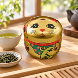 18SC1G gold-tone lucky cat tea container at a tea station