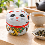 18SC1W white lucky cat tea container beside tea and loose leaves