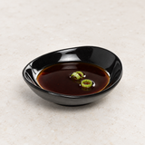Melamine Round Soy Sauce Plate 3-1/2"x3/4", Black. Serving suggestion.