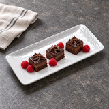 24110WT white textured rectangular melamine plate with three petite chocolate cakes and raspberries