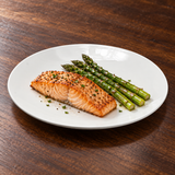 White round dinner plate with salmon and asparagus