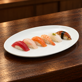 White oval platter with six nigiri pieces