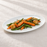 White oval platter with roasted vegetables