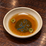 Amber dipping sauce in the 305-M beige and green melamine sauce dish