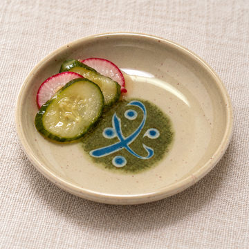 Cucumber and radish pickles in the 305-M beige and green melamine sauce dish