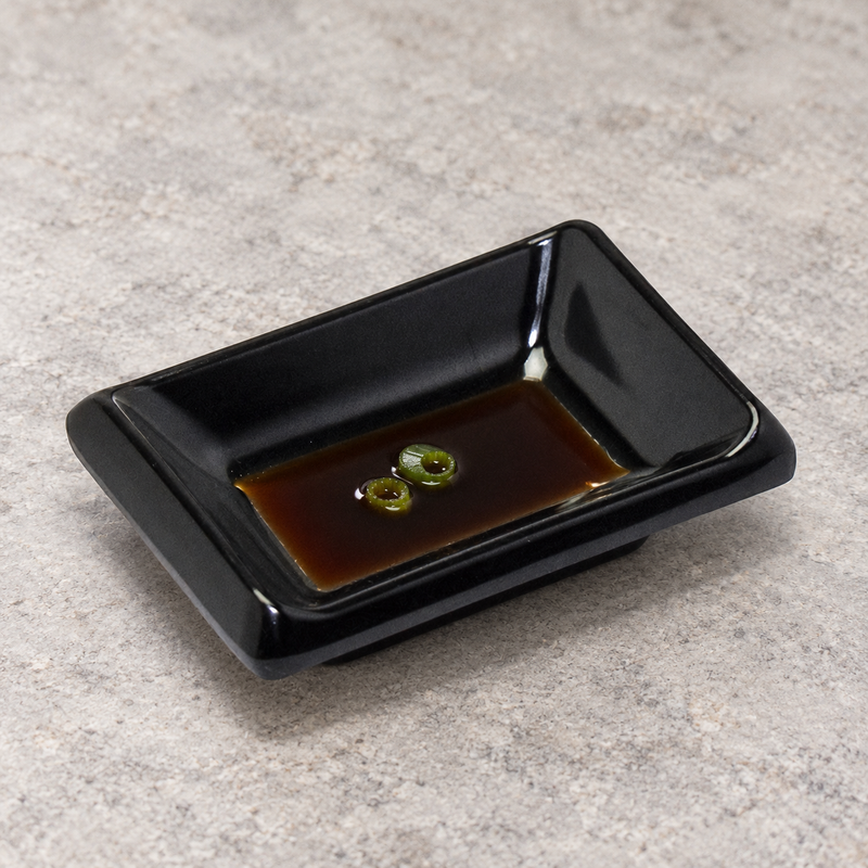 310/AB black rectangular melamine sauce dish with a small serving of soy sauce and scallion, serving suggestion