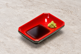 311-BR: Melamine Rectangular Sauce Dish 3-5/8"x2-1/2", Black/Red. Restaurant serving context