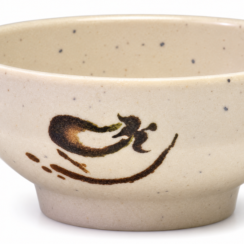 Close-up of the brown eggplant motif and speckled beige sauce bowl.