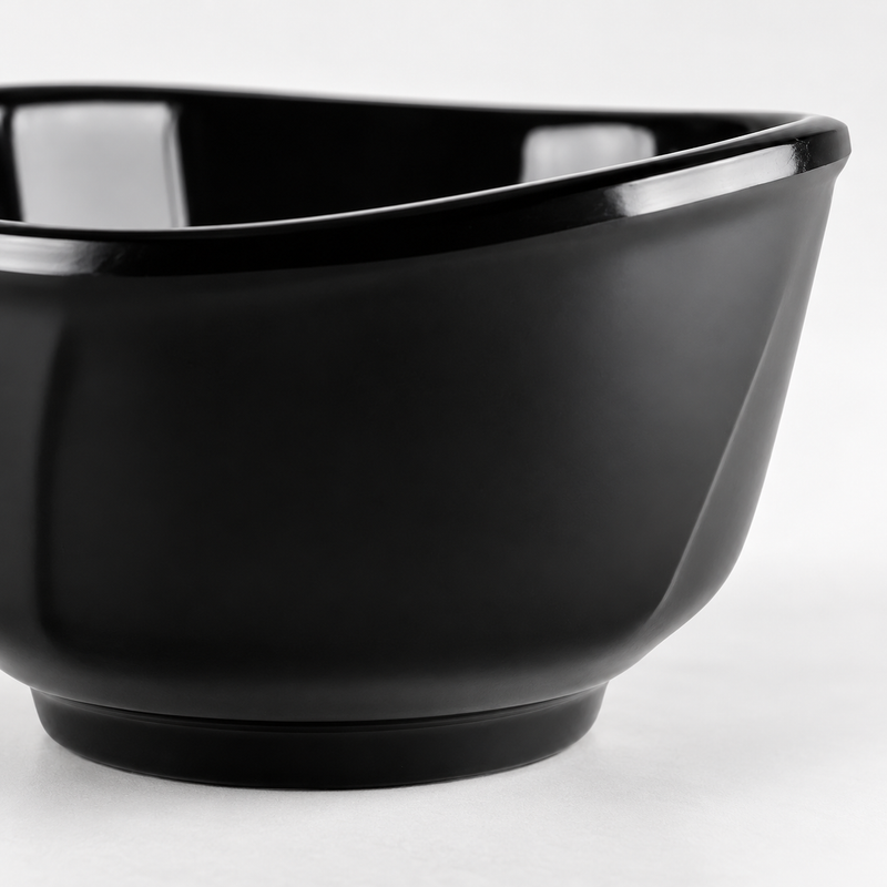 Close view of the black 39055BK melamine bowl showing its gently waved rim, curved sides and circular foot.
