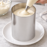 Mousse being piped into Paderno 47534-09 tall pastry ring supported on a separate plate