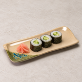 Three cucumber sushi rolls and pink pickled ginger arranged on the 510-M long rectangular patterned plate.