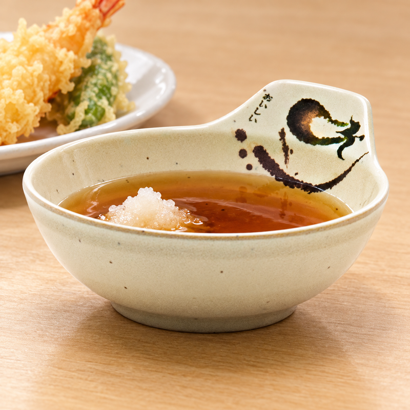 Eggplant-pattern tempura sauce bowl with dipping sauce and grated daikon beside tempura.