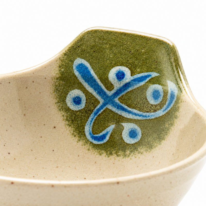 Close detail of the 5100-M bowl’s raised green back with a blue curling motif and beige rim; the lower bowl and foot are outside the crop.