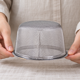 5490-80 inverted fine mesh tea basket held carefully at the rim