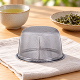 5490-80 inverted fine mesh tea basket on linen beside separate tea accessories