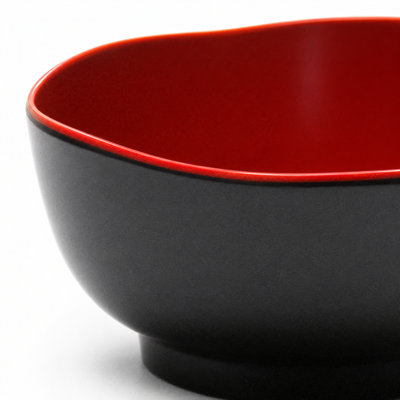 Detail of the shaped red rim and black exterior of the 605D-BR petal rice bowl.