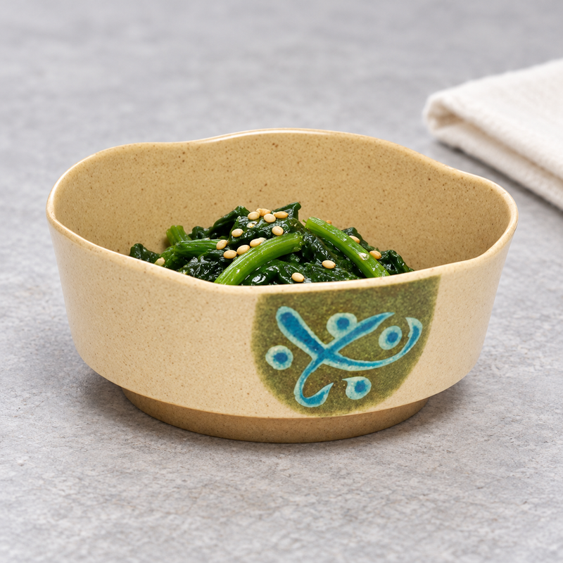 605E-M petal bowl with a green vegetable side topped with sesame seeds, with a folded napkin behind it.