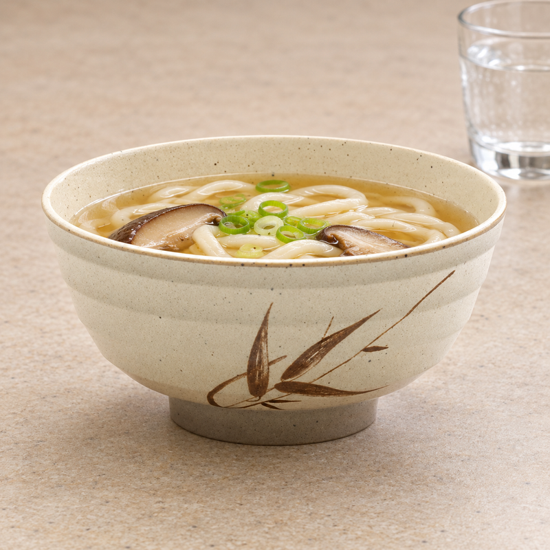 Autumn Grass bowl holding noodle soup with mushrooms and scallions.