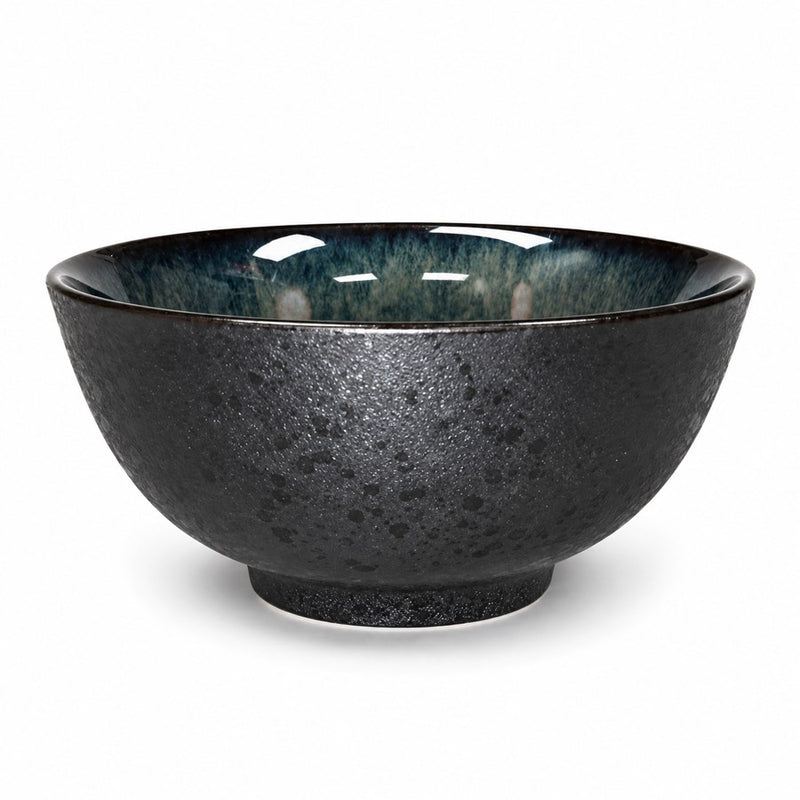 Deep obsidian ceramic bowl with dark mottled exterior, blue-green interior, narrow brown rim and raised ring foot.