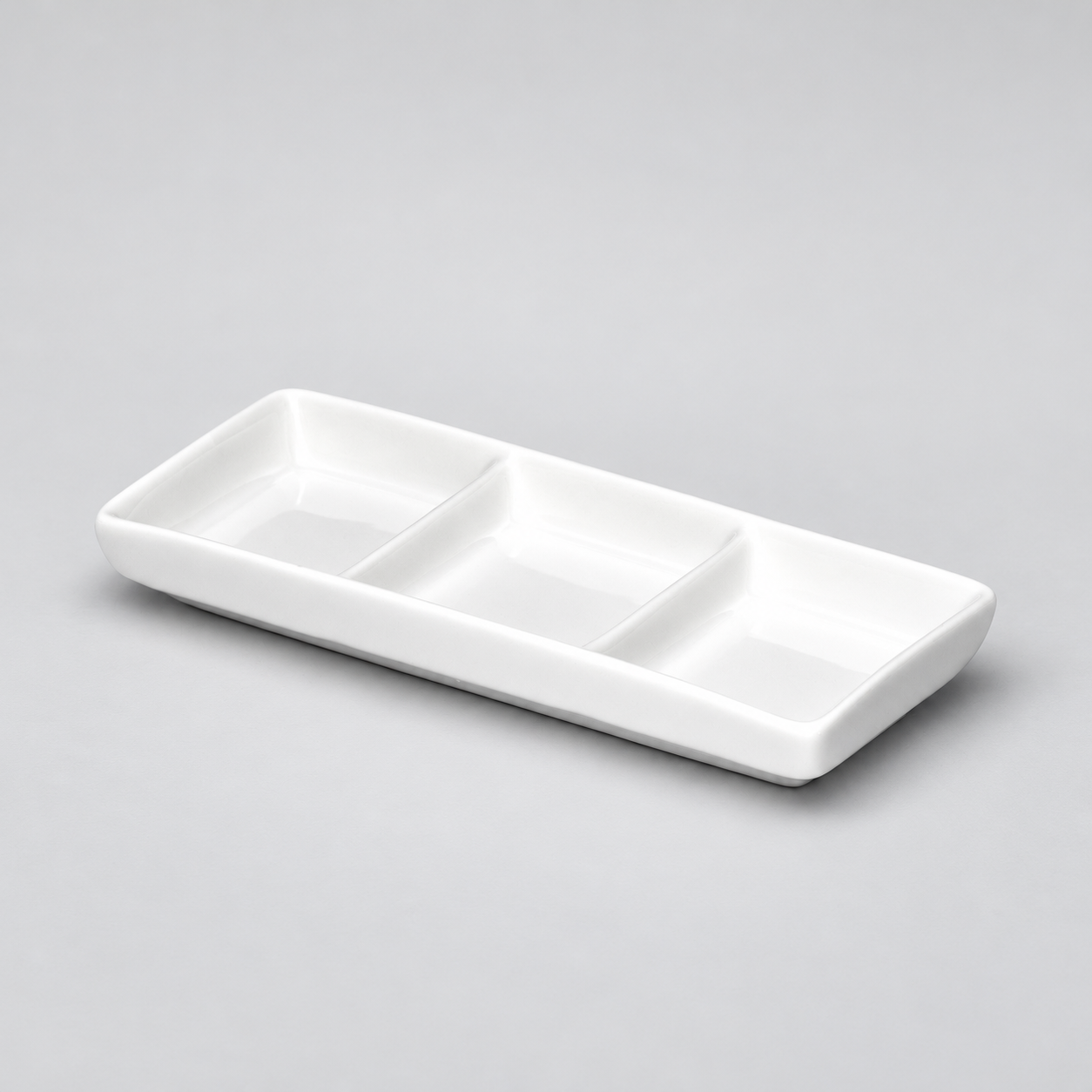 3-Compartment Sauce Plate 6"x2-1/2", White Ceramic. Angled product view.