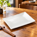 Empty A0941 white crosshatched ceramic rectangular plate on a wooden table