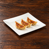 A1277 white ceramic square plate with a modest dumpling serving