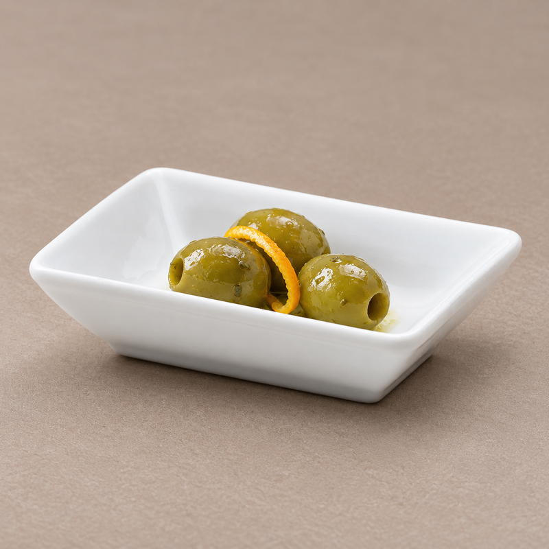 Serving suggestion with green olives and a curl of citrus peel in the A16850 white rectangular plate