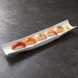 A17066 white ceramic bamboo-shaped platter with five pieces of nigiri sushi.