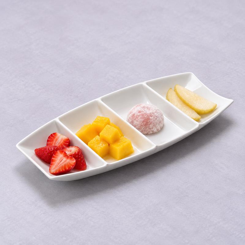 A18685 divided white boat plate with strawberries, mango, pink mochi and pear as a dessert suggestion.