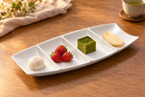 A18686 four-compartment white boat plate with mochi, berries, cake and pear; dessert serving suggestion