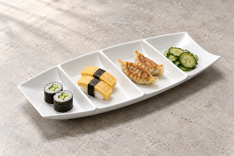 A18686 white ceramic four-compartment boat plate with small sushi, dumpling and pickle portions; serving suggestion
