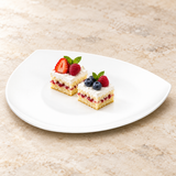 A2018 white ceramic triangular plate with a small dessert presentation on a restaurant tabletop; food not included.