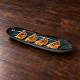 13.5" × 4" Obsidian Ceramic Serving Platter with a restaurant serving