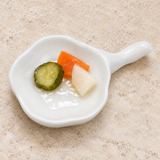 A3507 white ceramic dish with a small pickle selection on a restaurant tabletop; food and accessories not included.