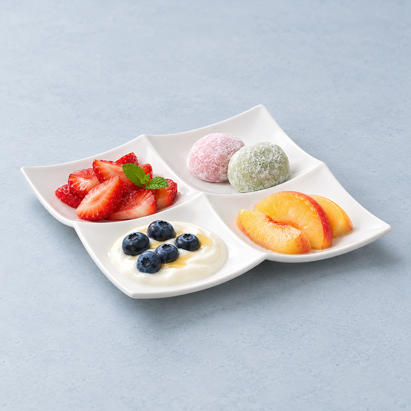 A4140 four-section plate with fruit, small round sweets and a creamy component topped with blueberries as a dessert suggestion.