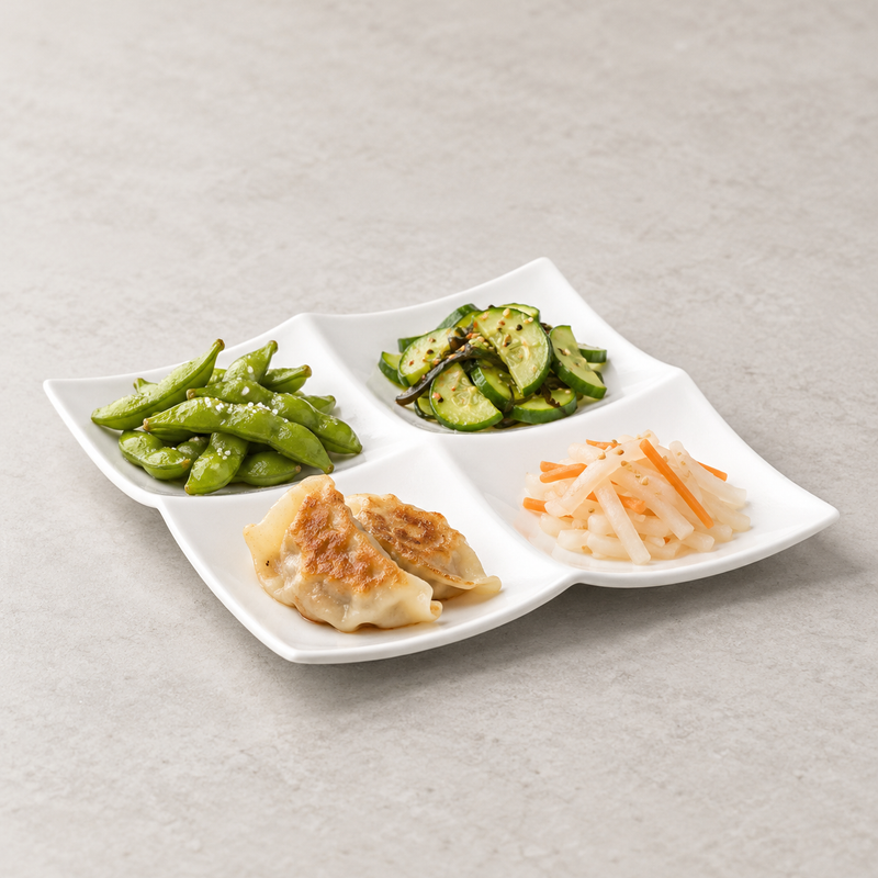 A4140 four-section plate with dumplings, edamame, cucumber and cut vegetables as an appetizer suggestion.
