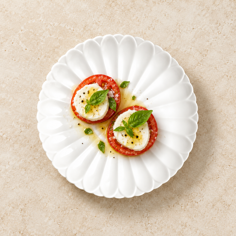 A4276 scalloped white plate with tomato, white cheese and basil as a starter suggestion.