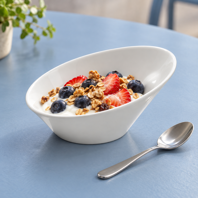 Breakfast serving suggestion of yogurt, strawberries, blueberries and granola in the white A4308 slanted bowl.