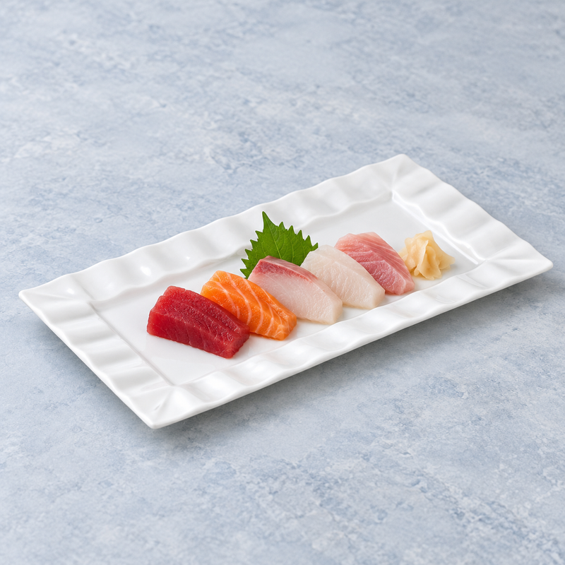 A4371 ruffle-rim rectangular plate with assorted sashimi, a green leaf and pickled ginger as a serving suggestion.