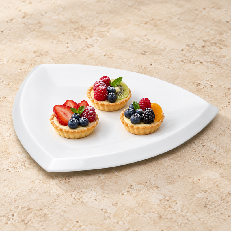A6956 white ceramic triangular plate with a small dessert presentation on a restaurant tabletop; food not included.