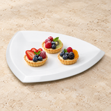 A6956 white ceramic triangular plate with a small dessert presentation on a restaurant tabletop; food not included.