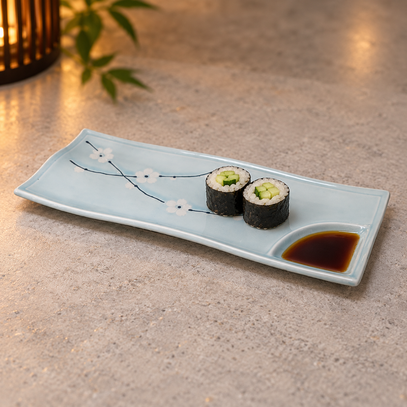 AS212-PL pale-blue plum-blossom divided plate with two cucumber maki and soy sauce in its corner well, serving suggestion