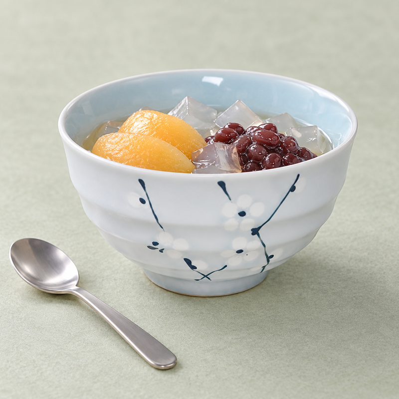 Floral ceramic bowl serving peach slices, red beans and translucent jelly