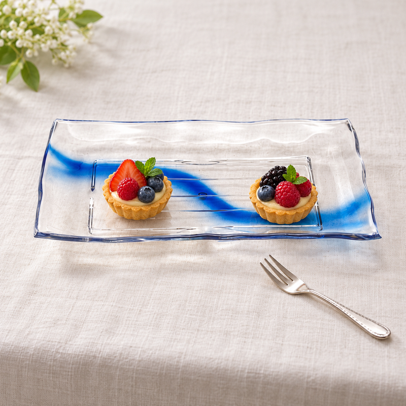 Clear blue-streak rectangular plate with two petite fruit tartlets on linen