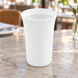 C318-01 plain white handleless cup with still water on a stone table