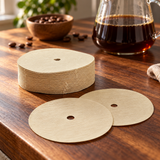 HARIO CF-103E round paper filters and loose sheets at a coffee preparation station